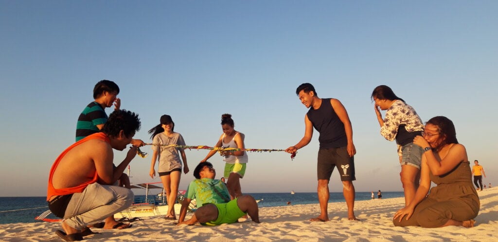 A group of people playing on the white sands